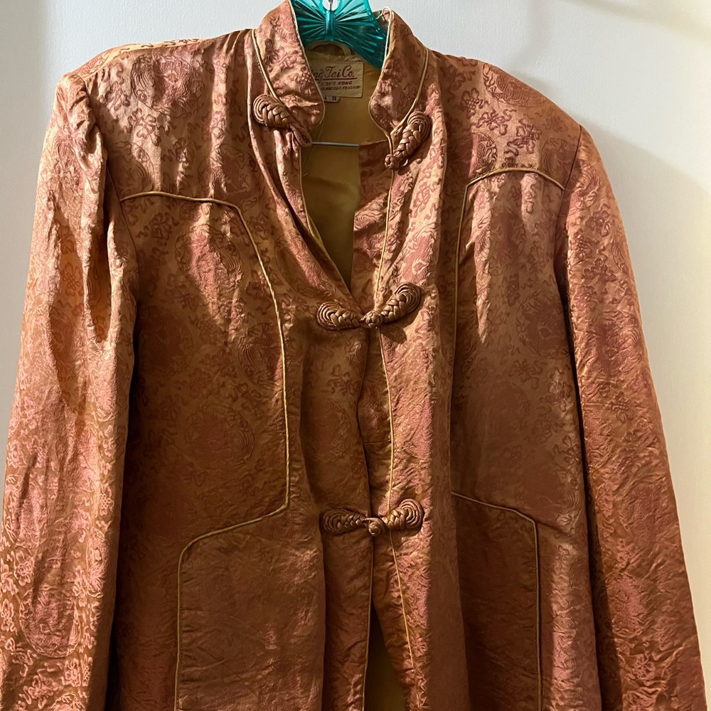 Vintage bed jacket in orange/rust. Size 38B. Has some damage due to age.
